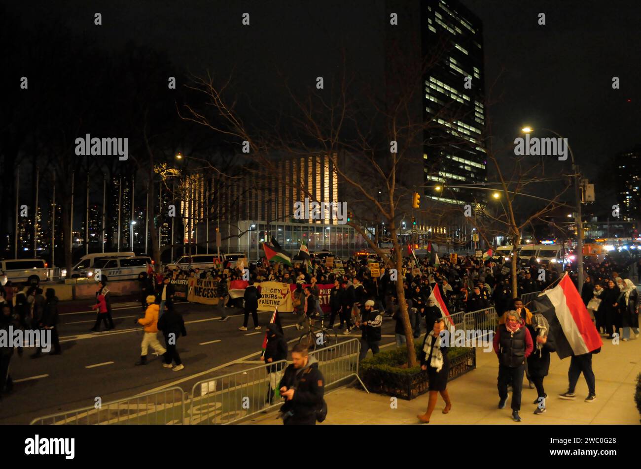 Protestors march in front of the United Nations Building as they hold banners, wave the Palestinian and Yemeni flags, and carry placards at a rally supporting Yemen and Palestine. Hundreds of demonstrators marched in Manhattan, New York City to condemn the U.S. and U.K. militaries who launched airstrikes on Thursday, January 11 against Houthi targets in Yemen. Demonstrators also demanded a permanent ceasefire in the war between Israel and Hamas, and an end to the Israeli military's bombardment of Gaza. According to U.S. President Joe Biden, the January 11 airstrikes in Yemen 'are in direct res Stock Photo