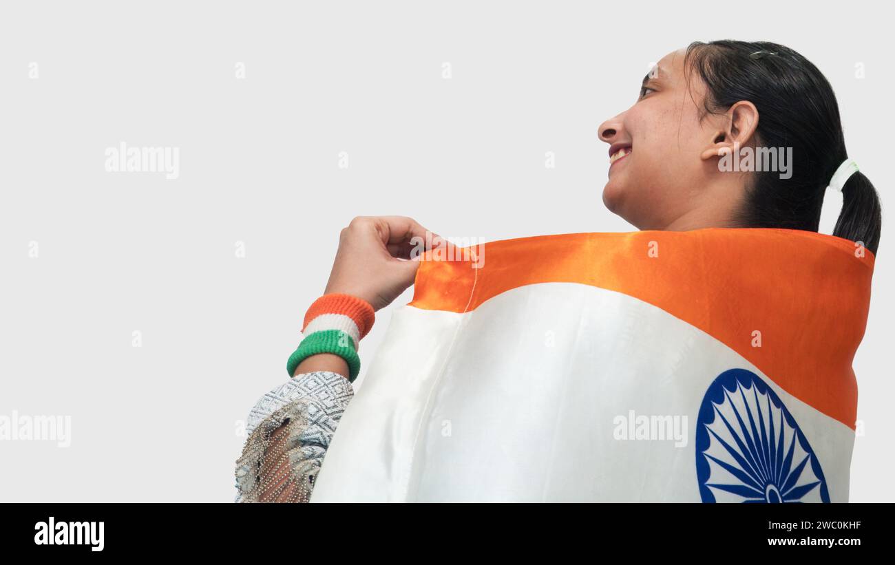 Backside view of young Indian girl showing pride to be Indian With national flag Stock Photo
