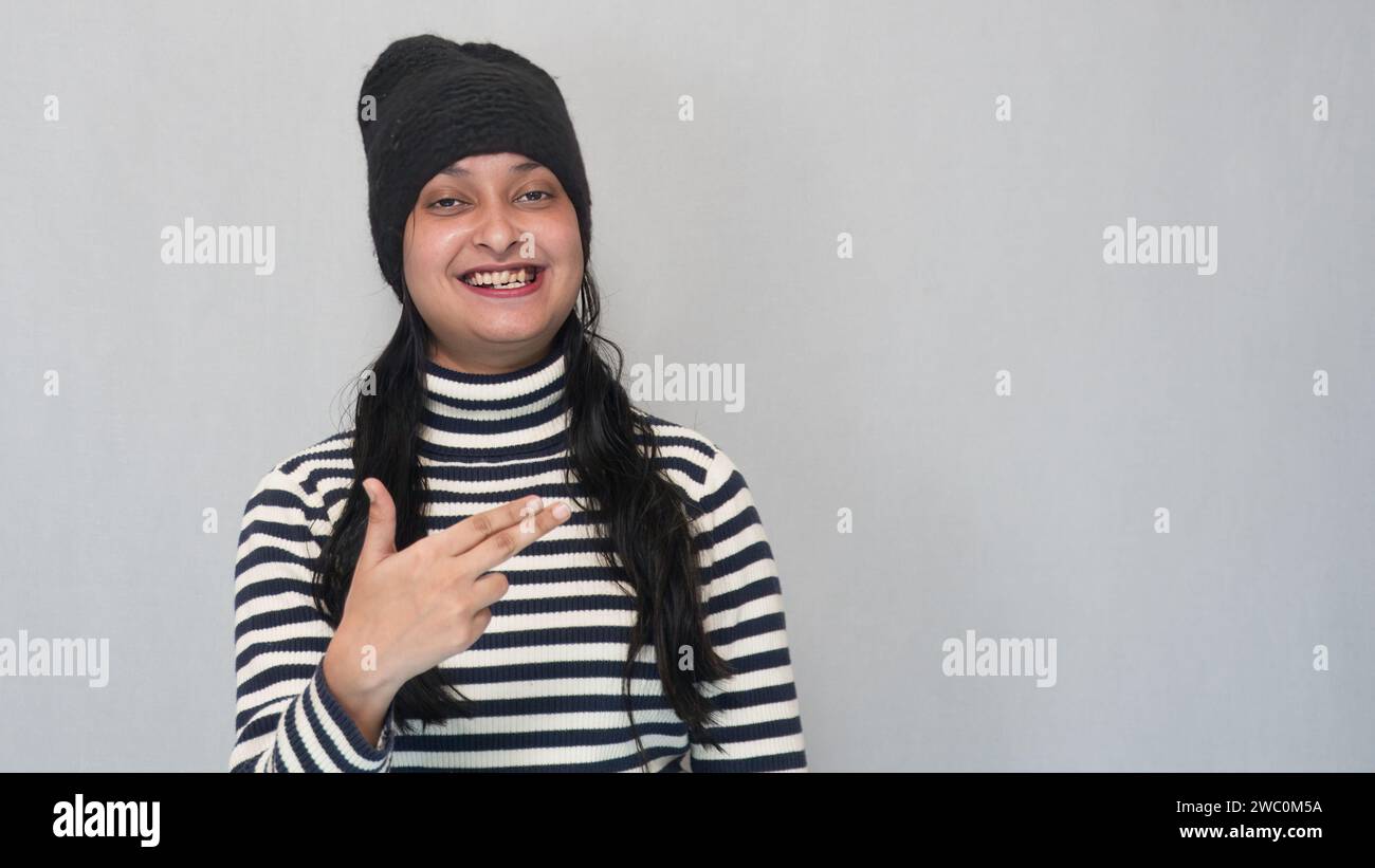 A Young teenage girl, wearing a turtleneck sweater, with a black woolen cap. Stock Photo