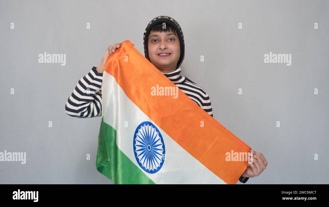 On 26th January in India, a young Indian girl holding a tricolor Indian flag. Stock Photo