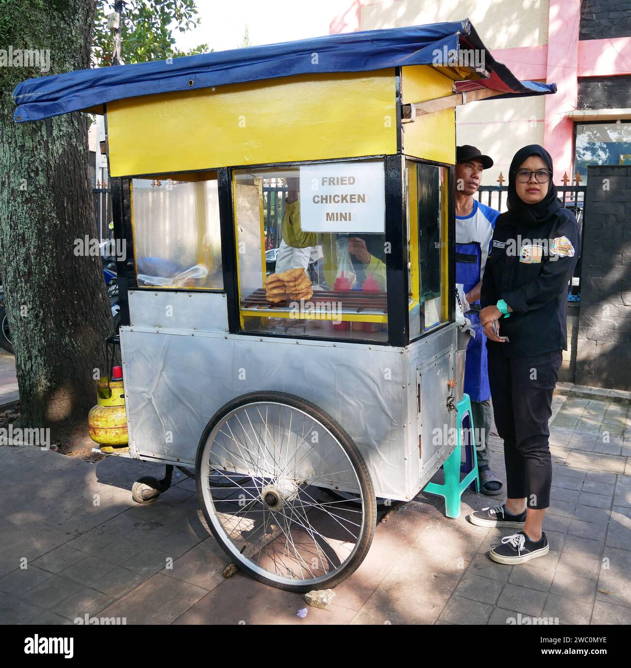 Indonesian Street Food Cart or Gerobak, a traditional push cart in Bandung, West Java, Indonesia selling Fried Chicken Mini. Stock Photo