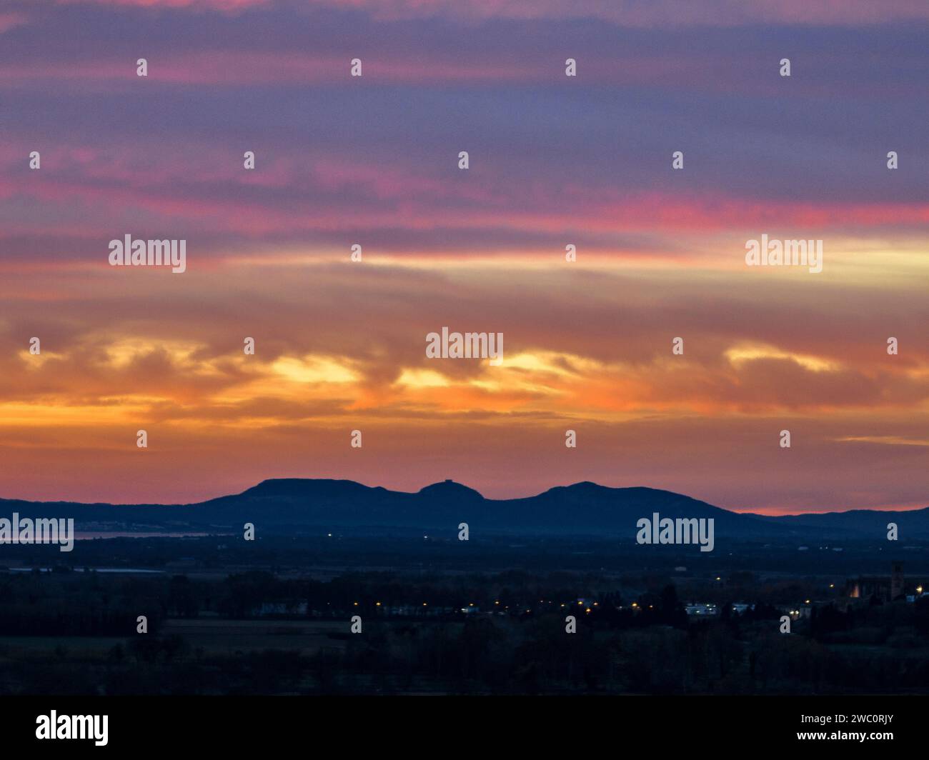 Aerial view of the Montgrí massif seen from near the Aiguamolls de l'Empordà (wetlands), in a red sunrise (Alt Empordà, Girona, Catalonia, Spain) Stock Photo