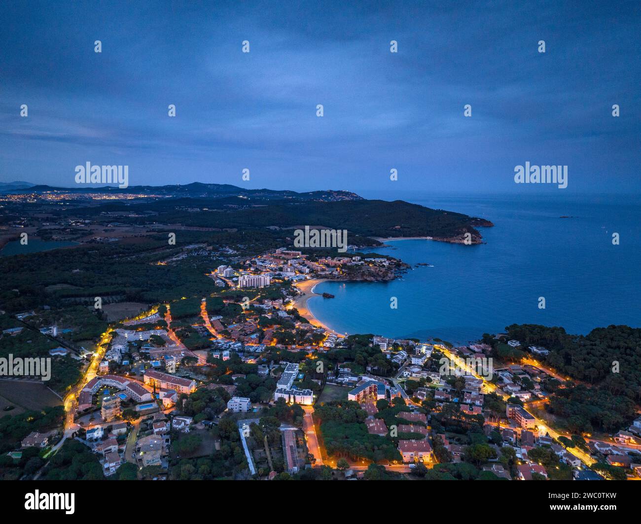 Sunset with a red sky over the bay and city of Palamós. Aerial view (Costa Brava, Baix Empordà, Girona, Catalonia, Spain) Stock Photo