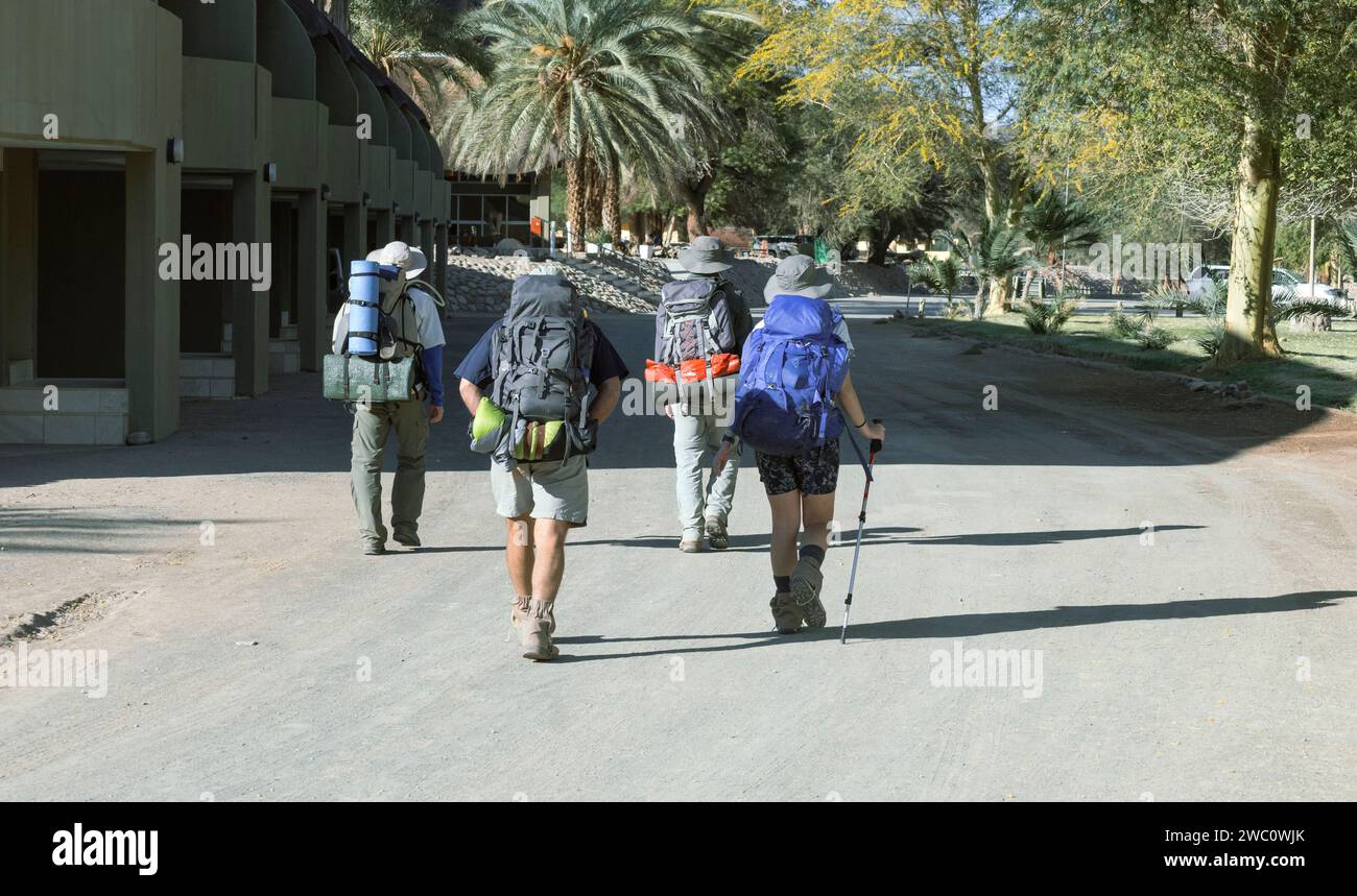 A group of hikers make their way to the campsite at the end of the Fish River Canyon walk in Ais Ais in Namibia Stock Photo