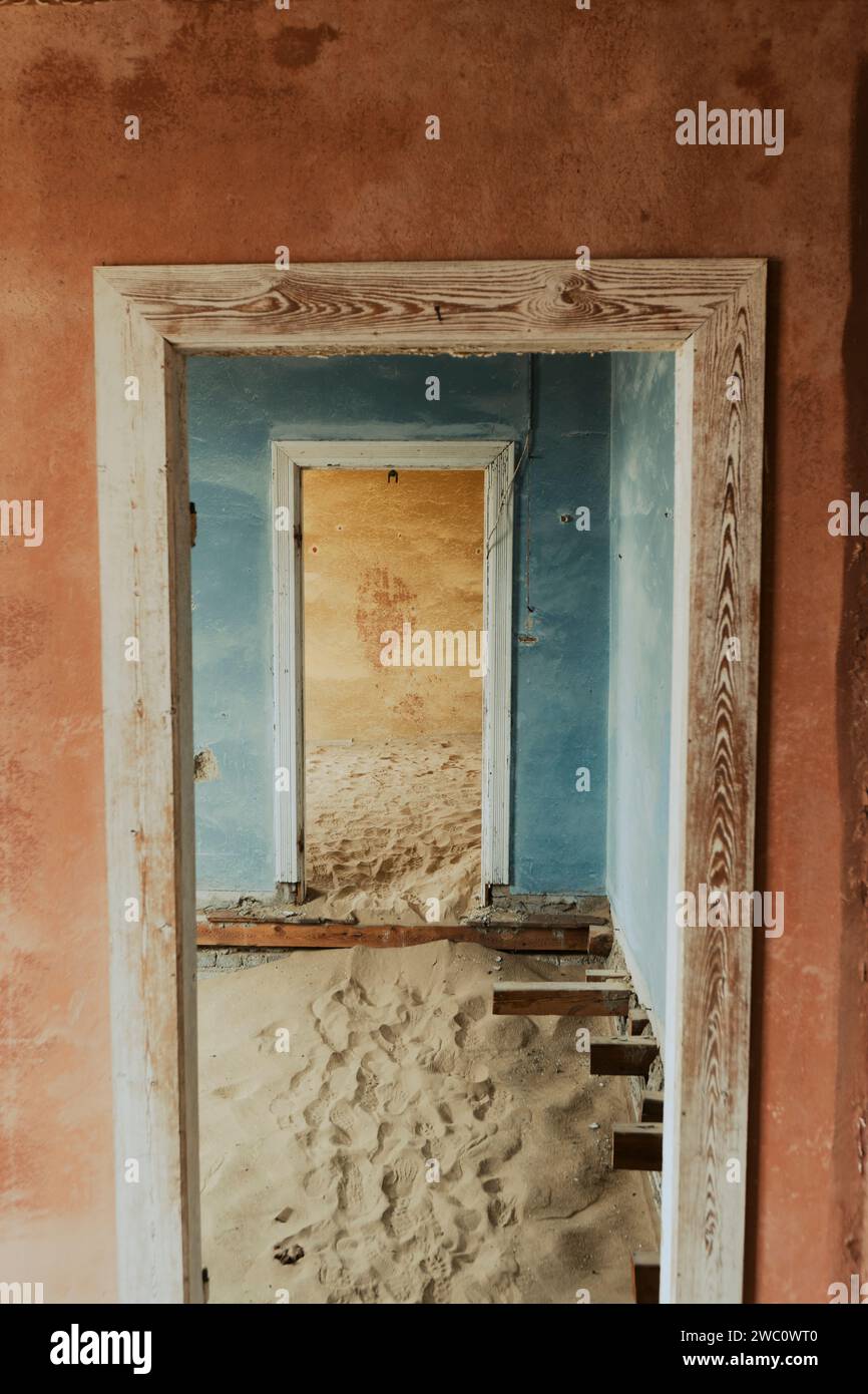 Two doorways of an empty house with sand covering the ground in Kolmanskop in Namibia Stock