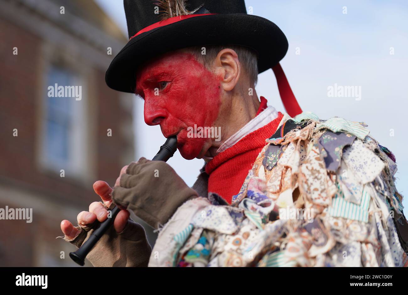 Red Leicester Morris dancers perform as the Straw Bear is paraded