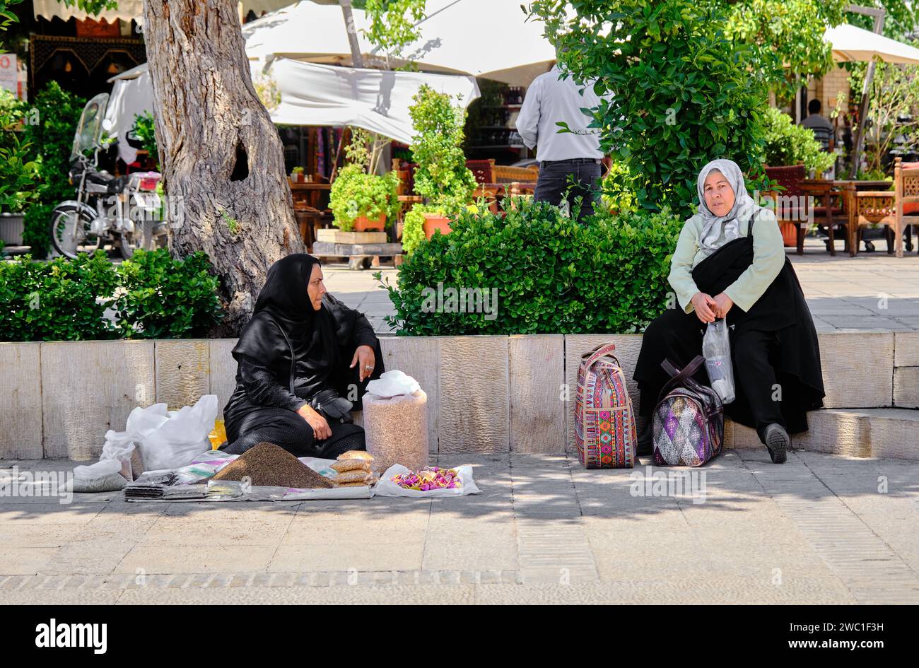 Shiraz, Iran 06.26.2023: Two old iranian women, talking each other, sells local food. Stock Photo