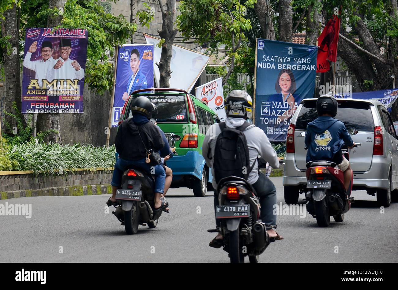 Bogor, West Java, Indonesia. 13th Jan, 2024. Motorcyclists past the billboard of one pairs of candidates and other legislative candidates along a street in Bogor, West Java, Indonesia on January 13, 2024, ahead of Indonesia's upcoming general election scheduled to be held on February 14. (Credit Image: © Adriana Adie/ZUMA Press Wire) EDITORIAL USAGE ONLY! Not for Commercial USAGE! Stock Photo