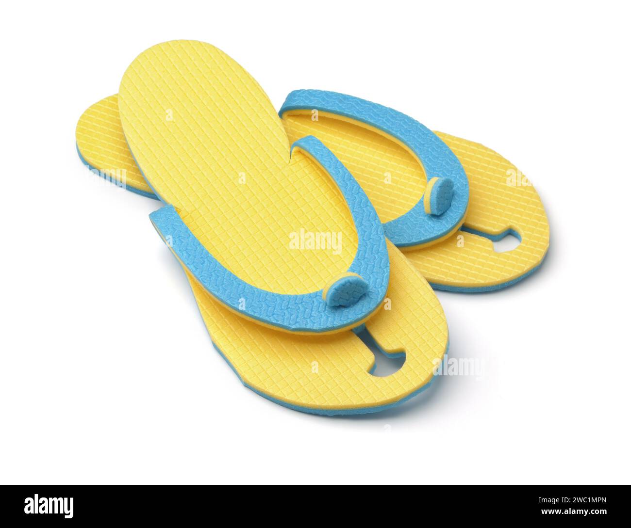 Pair of yellow disposable foam flip flops isolated on white Stock Photo