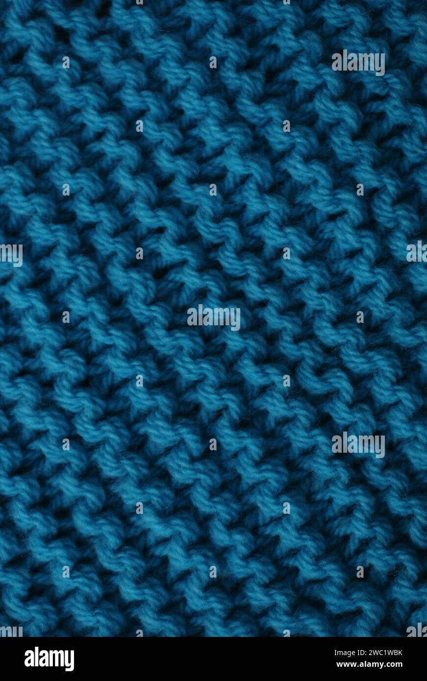 Crochet texture of woolen fabric close-up. The surface is knitted with ...