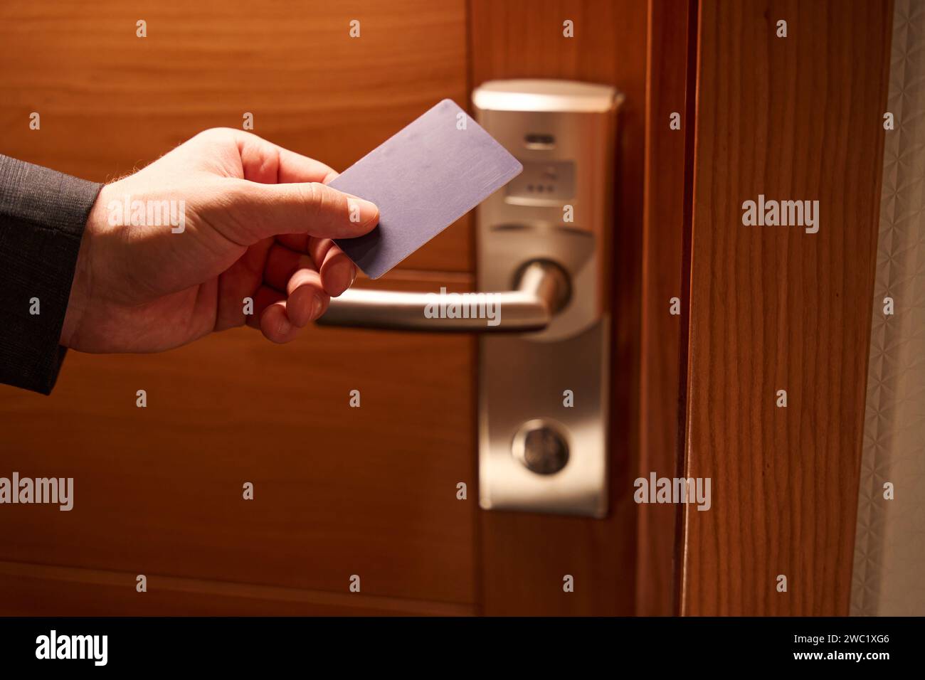 Cropped photo of man hand unlocking door with keycard Stock Photo - Alamy