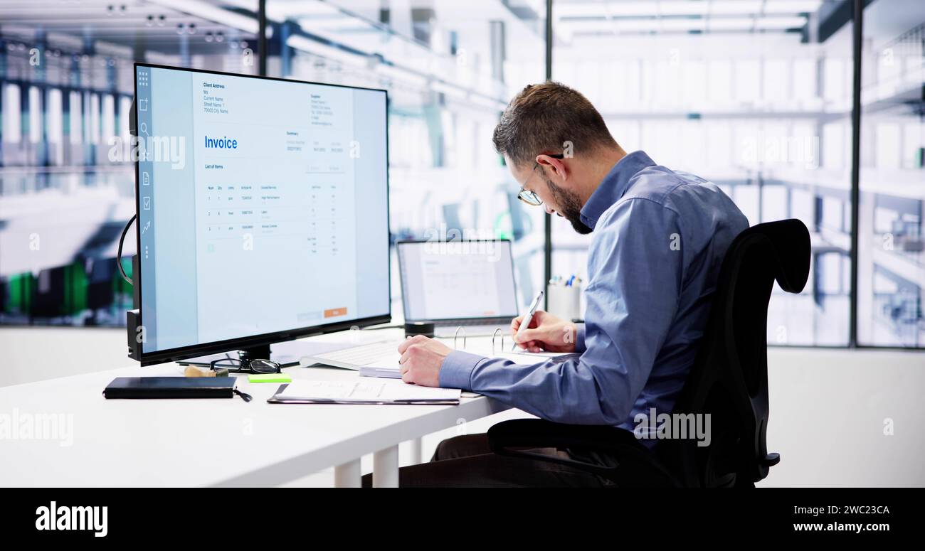Businessperson Analyzing Invoice On Computer In Office Stock Photo