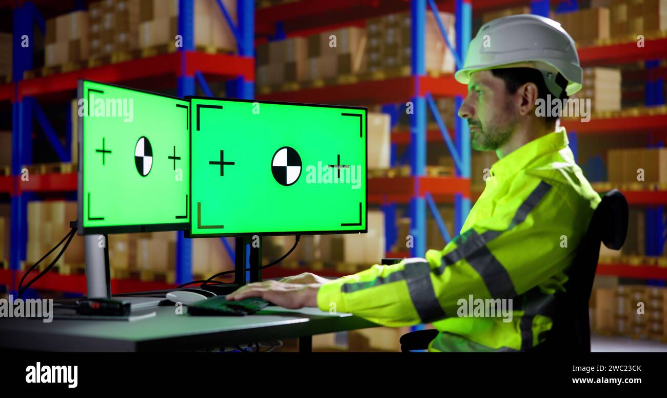 Engineer Using PC Monitor With Green Screen Stock Photo Alamy