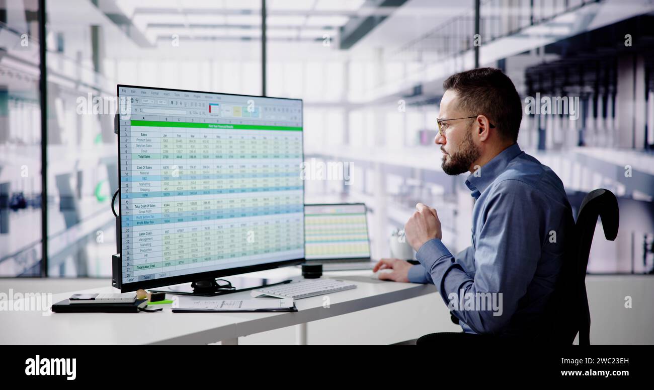 Data Analyst Man Using Spreadsheet On Computer Stock Photo