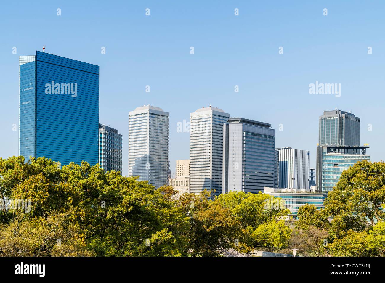 View from Osaka castle park of Osaka Business park with the Crystal Tower, Panasonic Twin Towers and others. Springtime, with clear blue sky. Stock Photo