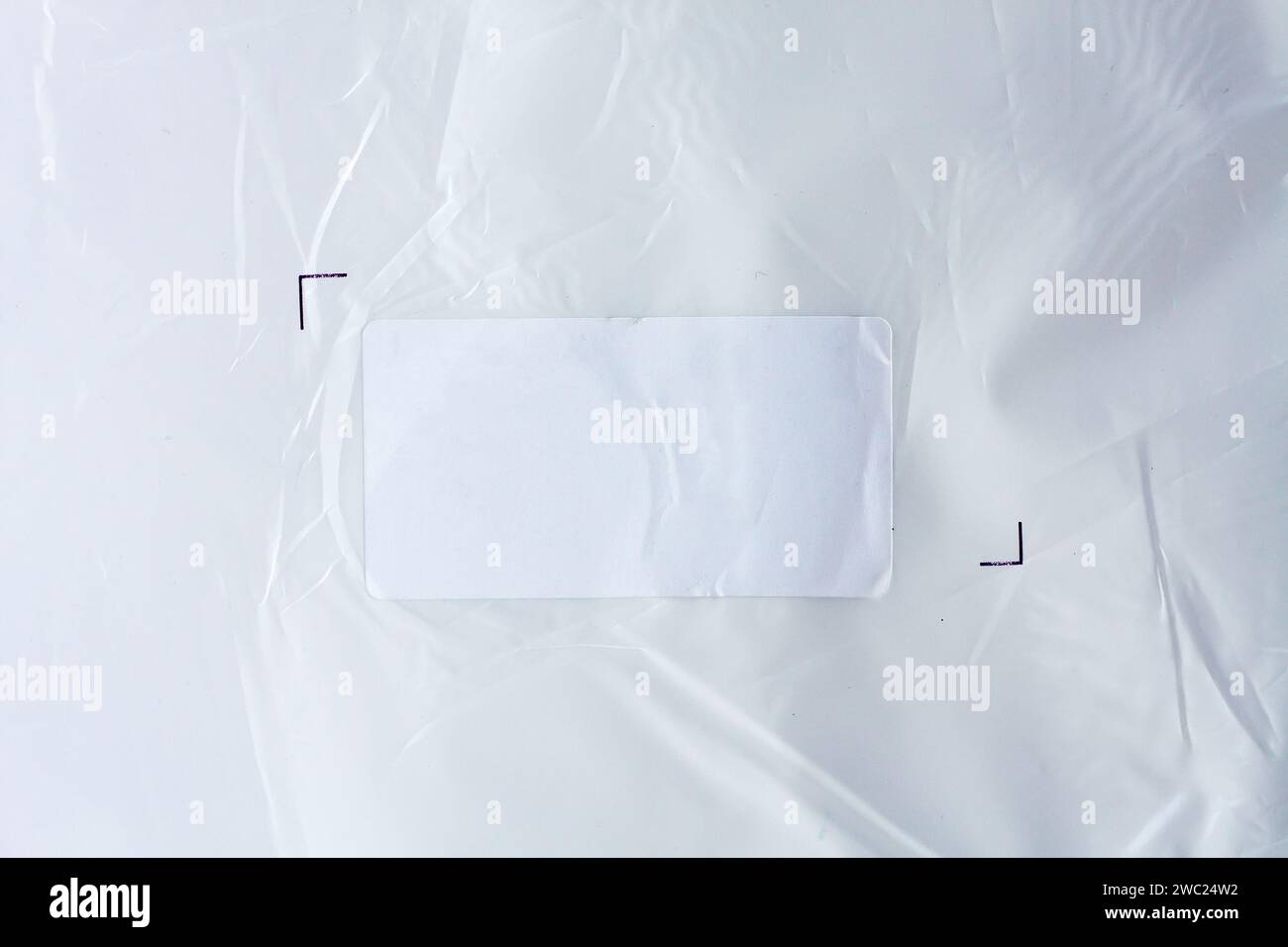 White sticker label on plastic background Stock Photo - Alamy