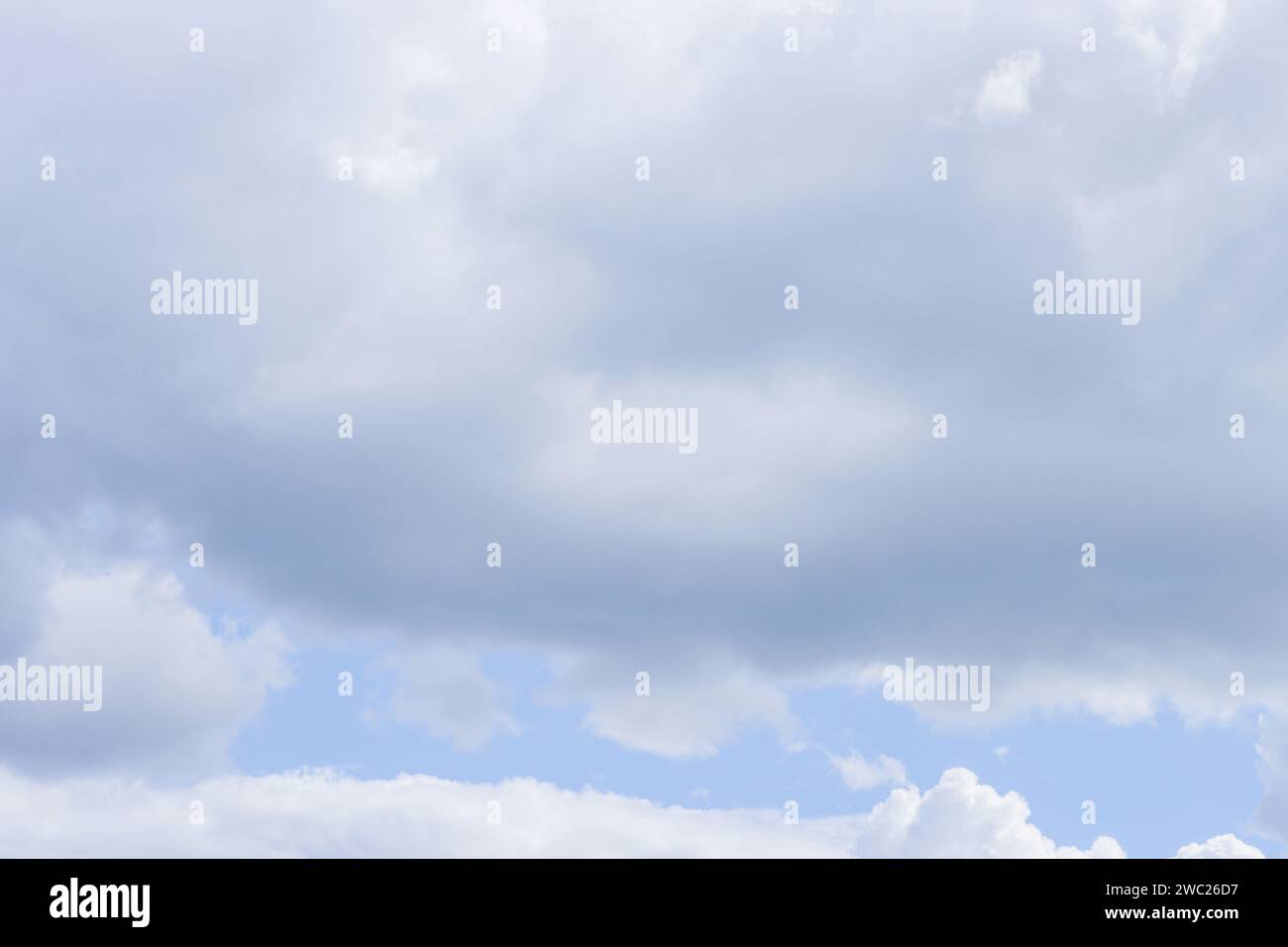 Overcast sky. Solid large light gray clouds. Stock Photo