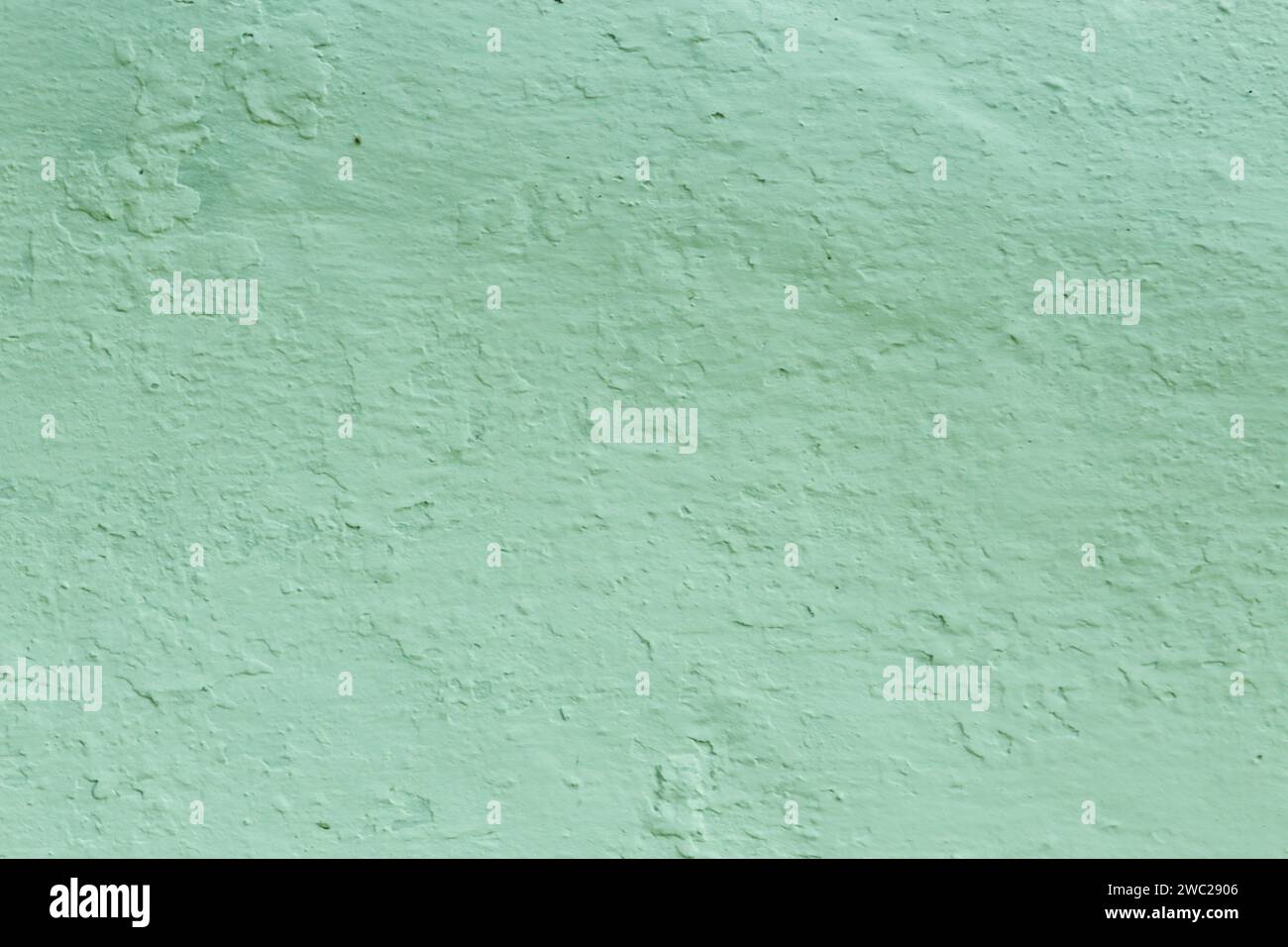 Green Textured Wall Background . The surface of the old pastel green plaster. Stock Photo