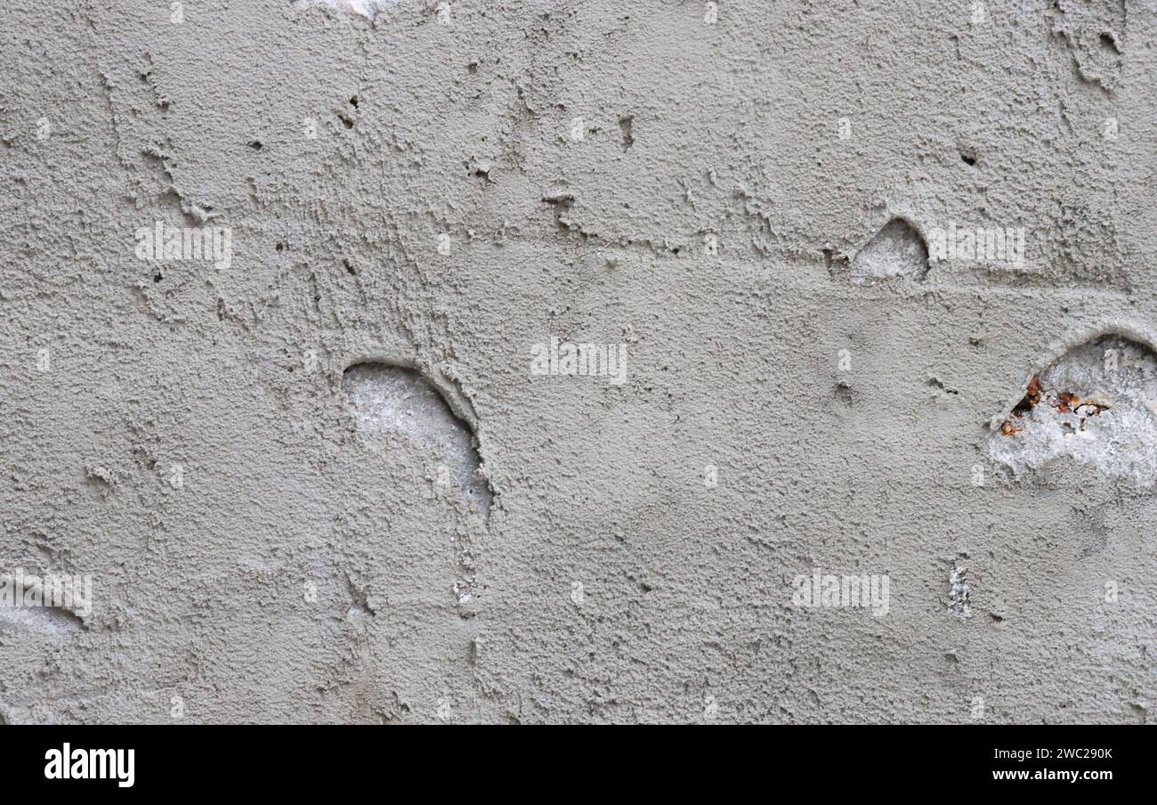 Abstract background from a wall covered with gray plaster. Stock Photo