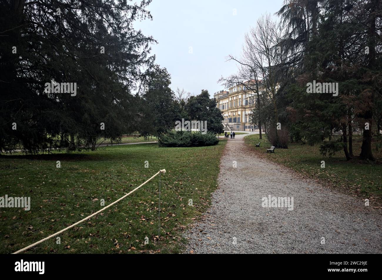 Mansion at the end of a path in a park on a cloudy day in autumn Stock Photo