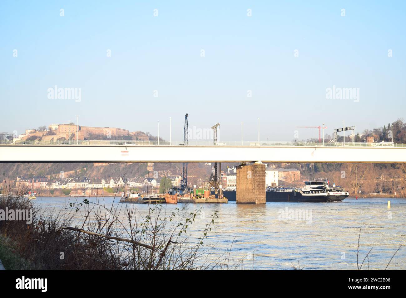 Pfaffendorfer Brücke, construction siste with cargos ships still passing Stock Photo