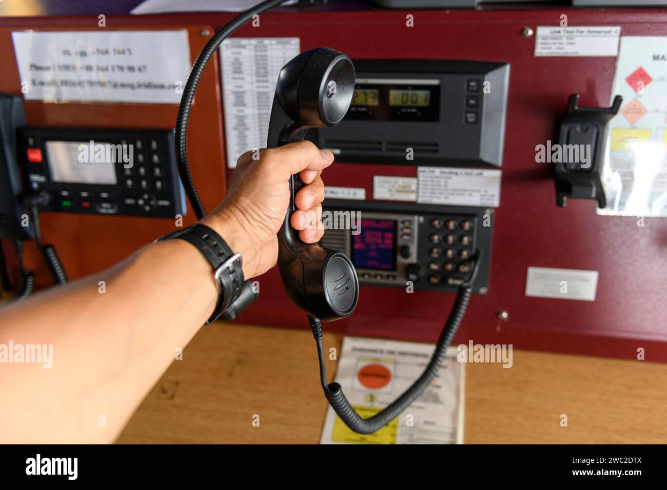 Navigational control panel and VHF radio with hand. Radio communication ...