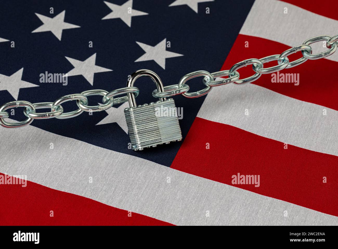 United States flag with unlocked chain. Border security, immigration reform and illegal migrant crisis concept. Stock Photo