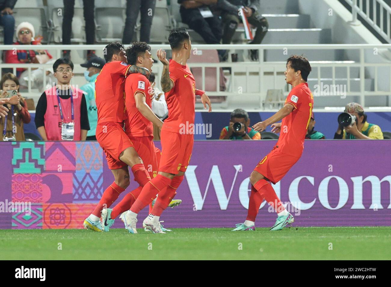 Doha, Qatar. 13th Jan, 2024. Players of China celebrates a goal which
