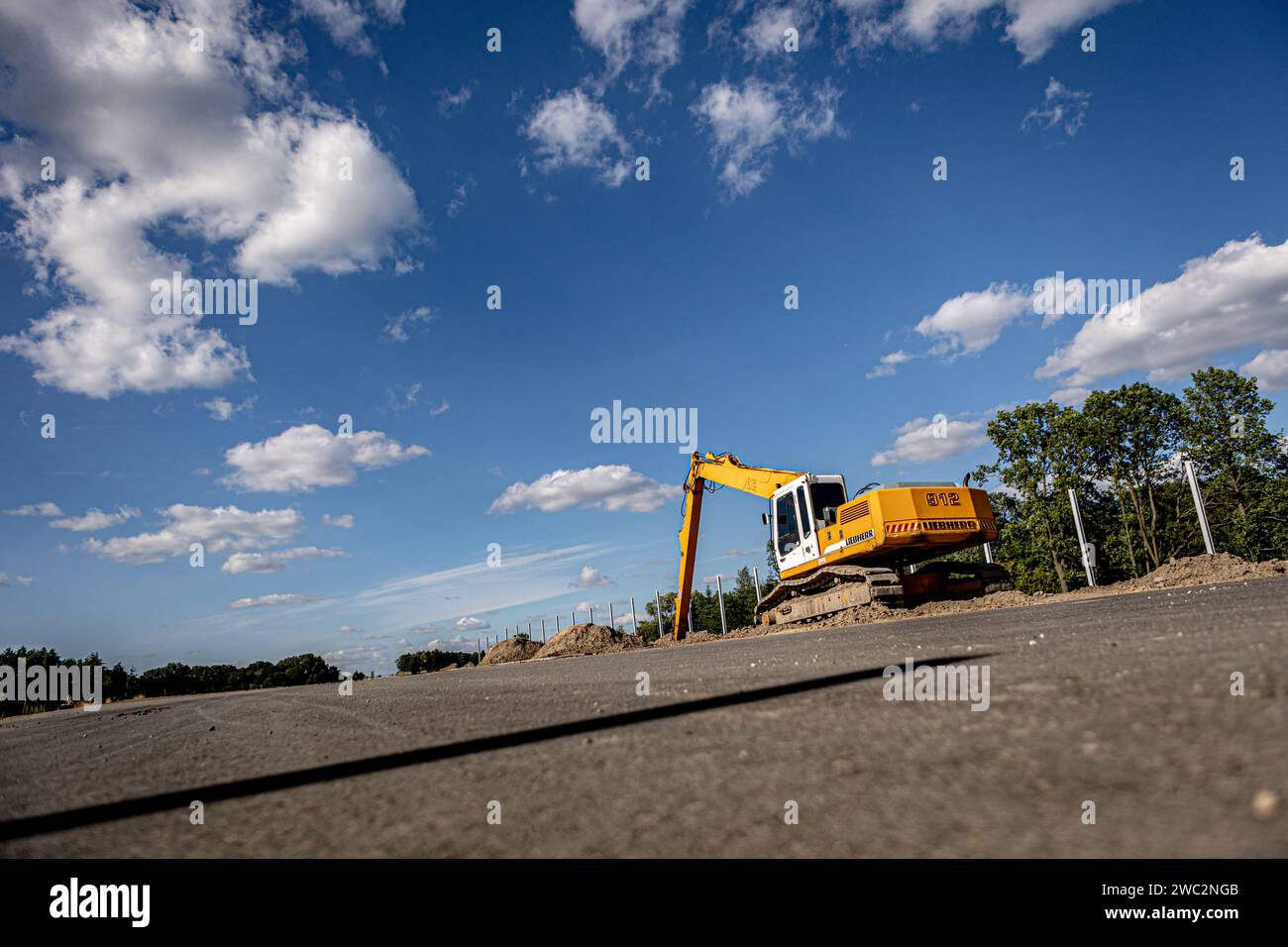 Highway construction. Pouring asphalt, installing sound barriers. Heavy