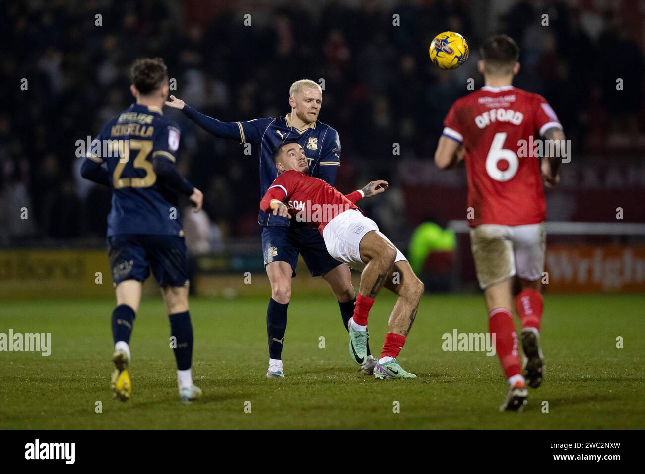 Crewe Alexandra's Courtney Baker-Richardson battles for possession with Swindon Town's Frazer Blake-Tracy during the Sky Bet League Two match at the Mornflake Stadium, Crewe. Picture date: Saturday January 13, 2024. Stock Photo