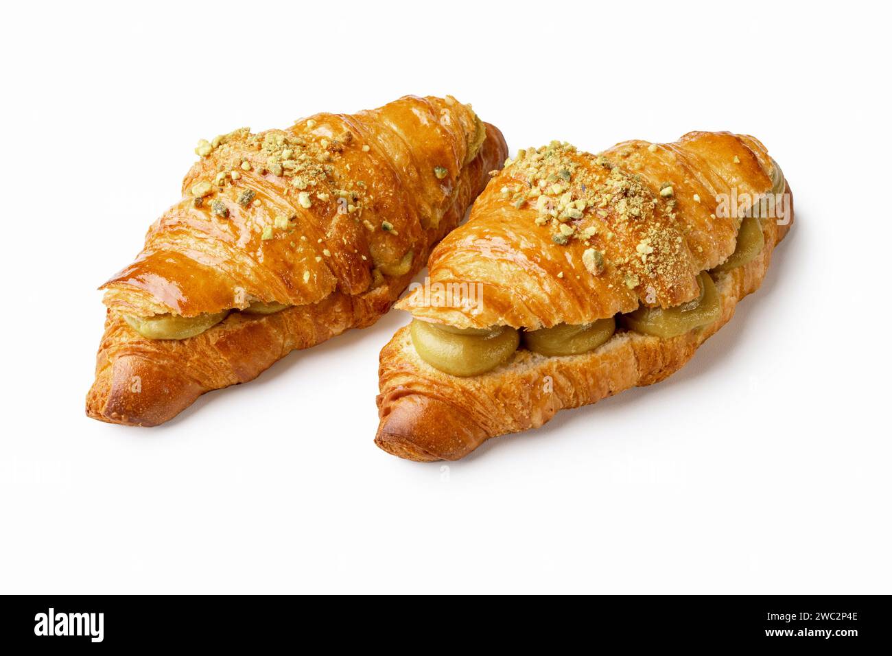 Indulge in flaky perfection with two pistachio cream croissants. the buttery layers and nutty filling create an irresistible, gourmet treat. ideal for Stock Photo