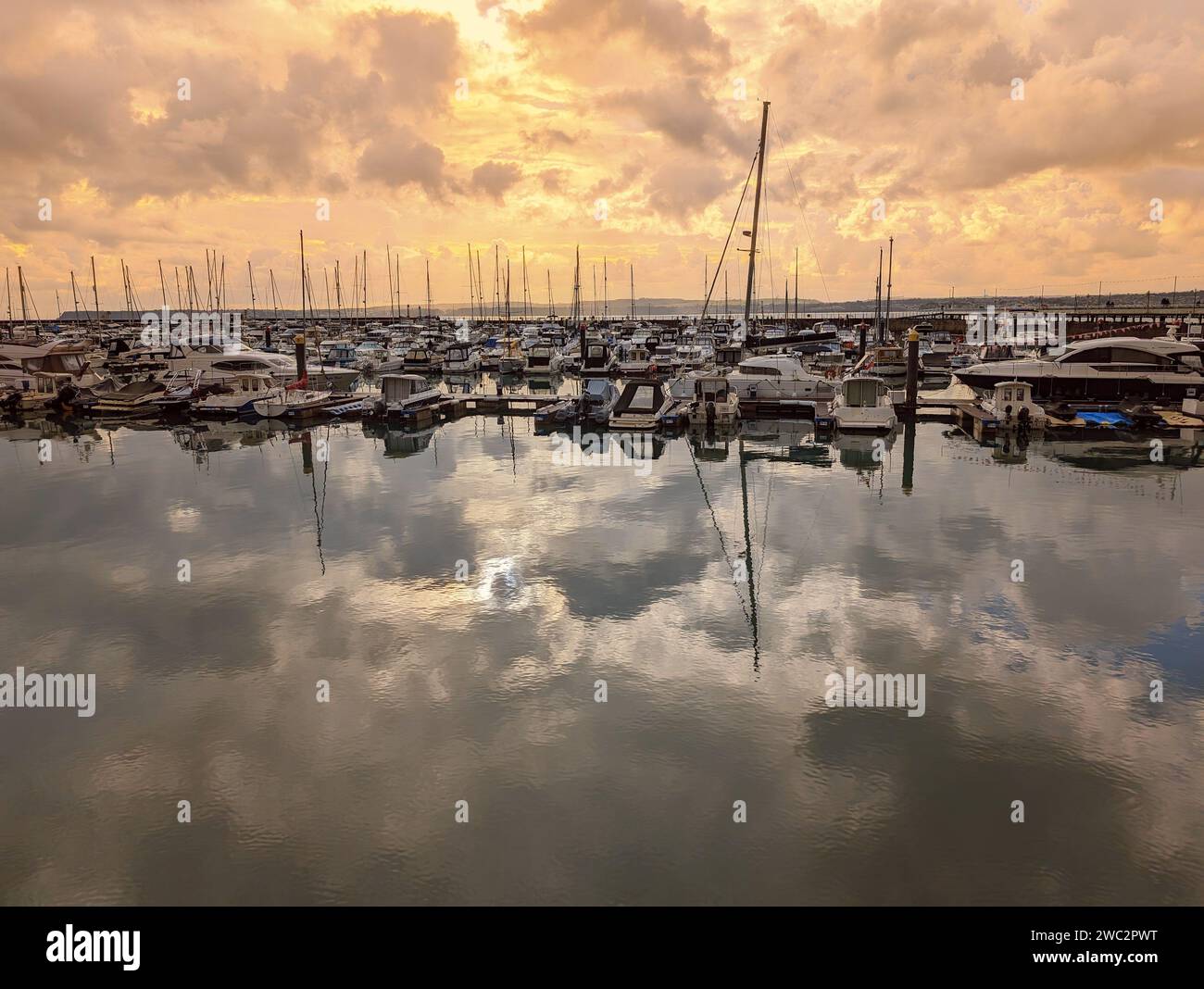 A fleet of boats docked in a marina, with calm waters creating a tranquil atmosphere. Torquay, England Stock Photo