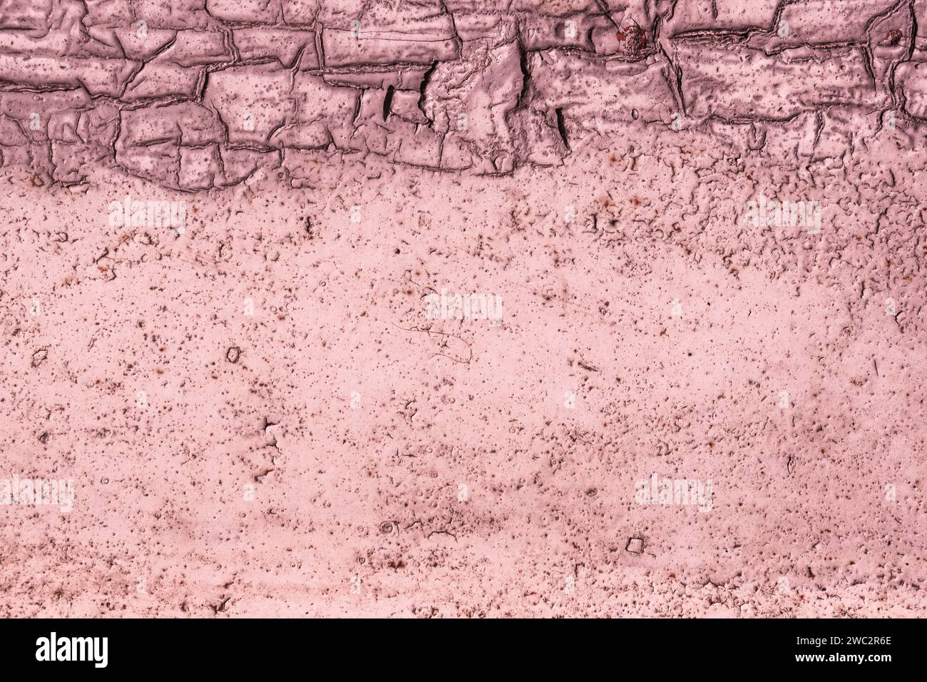 Wall surface with peeling magenta paint. Rusty iron surface. Stock Photo
