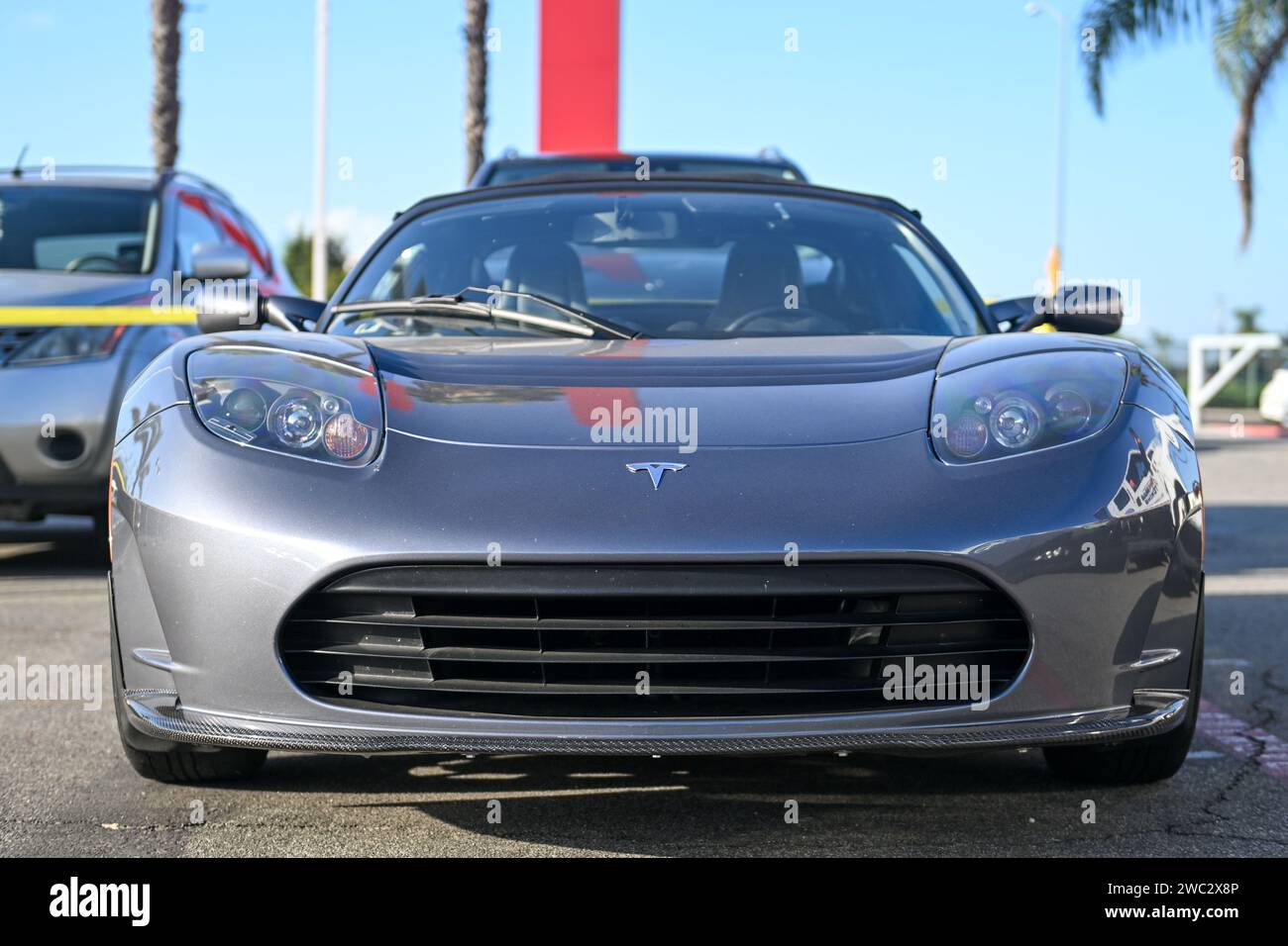 A Tesla Roadster (first generation) with the license plate “VIN1047” is seen parked at a Tesla dealership, Friday, Nov. 24, 2023, in Buena Park, Calif Stock Photo