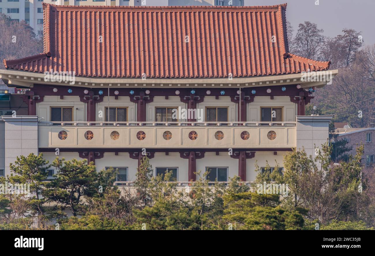 Daejeon, South Korea, March 13, 2017: Building with classical oriental styling with red clay tiled roof, metal mesh windows and intricate designs in Stock Photo