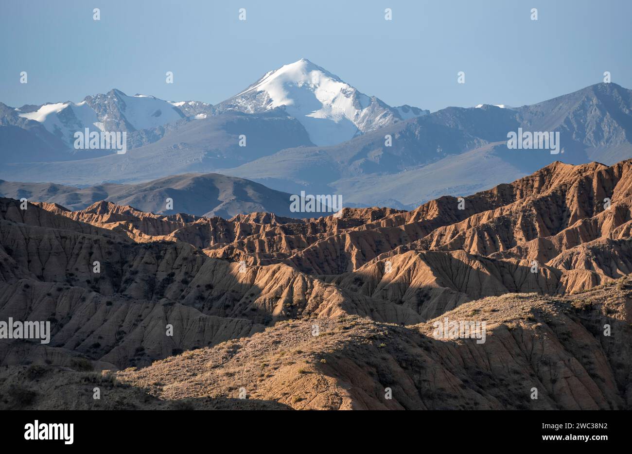 Tianshan Mountains Rivers Canyons, mountains of the Tian Shan in the background, eroded hills ...
