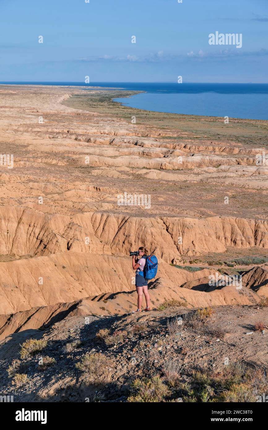 Photographer photographs canyons and eroded hilly landscape, Badlands ...