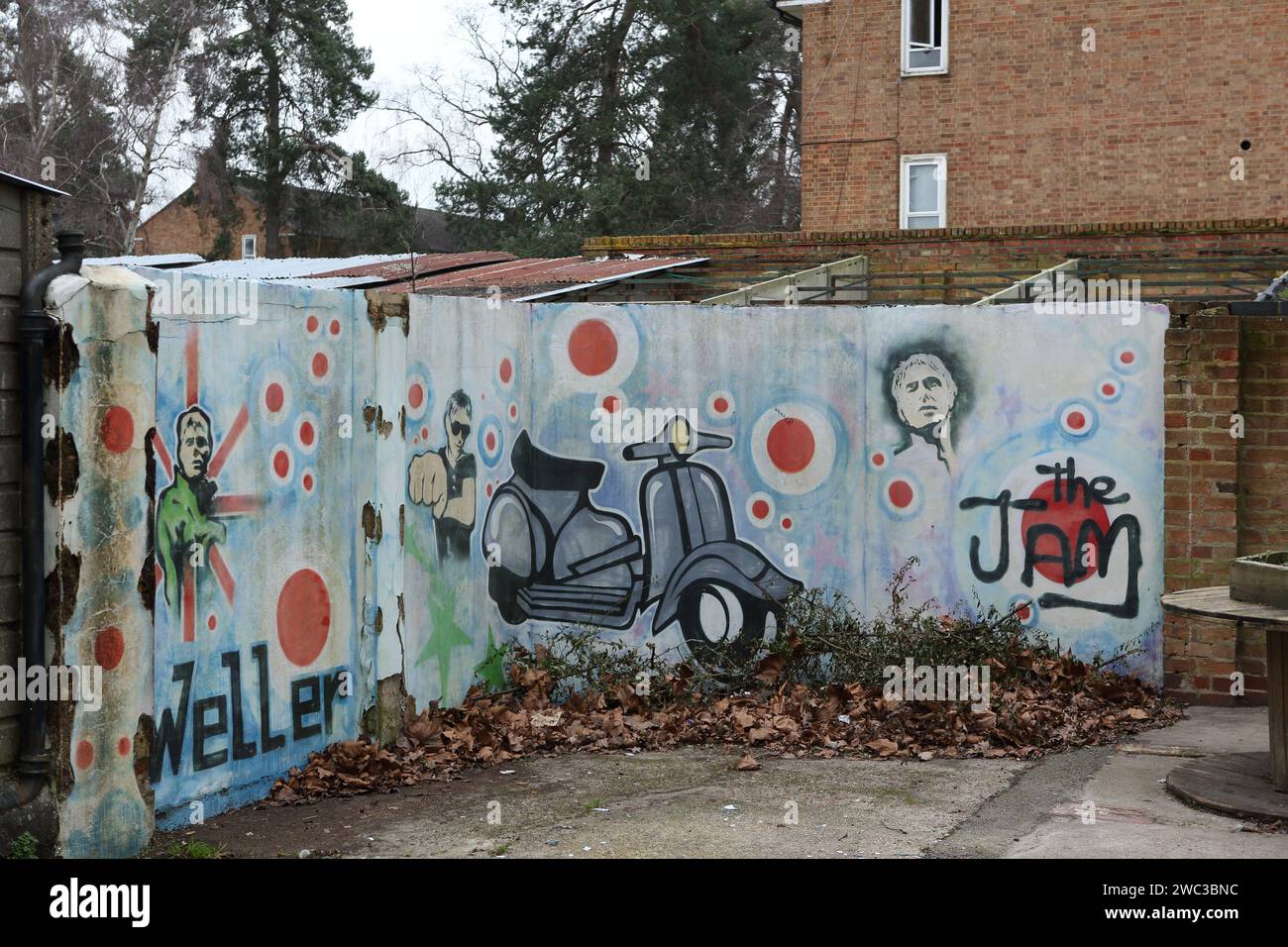 Sheerwater, Woking, Surrey. Wall mural with graffiti showing Paul Weller and scooter and name of The Jam Stock Photo