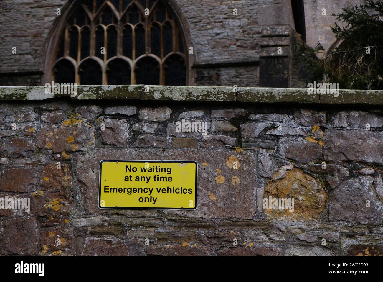 January 2024 - Sign on parking space reserved for emergency Vehicles beside St Mary's church in Yatton, North Somerset, England, UK. Stock Photo