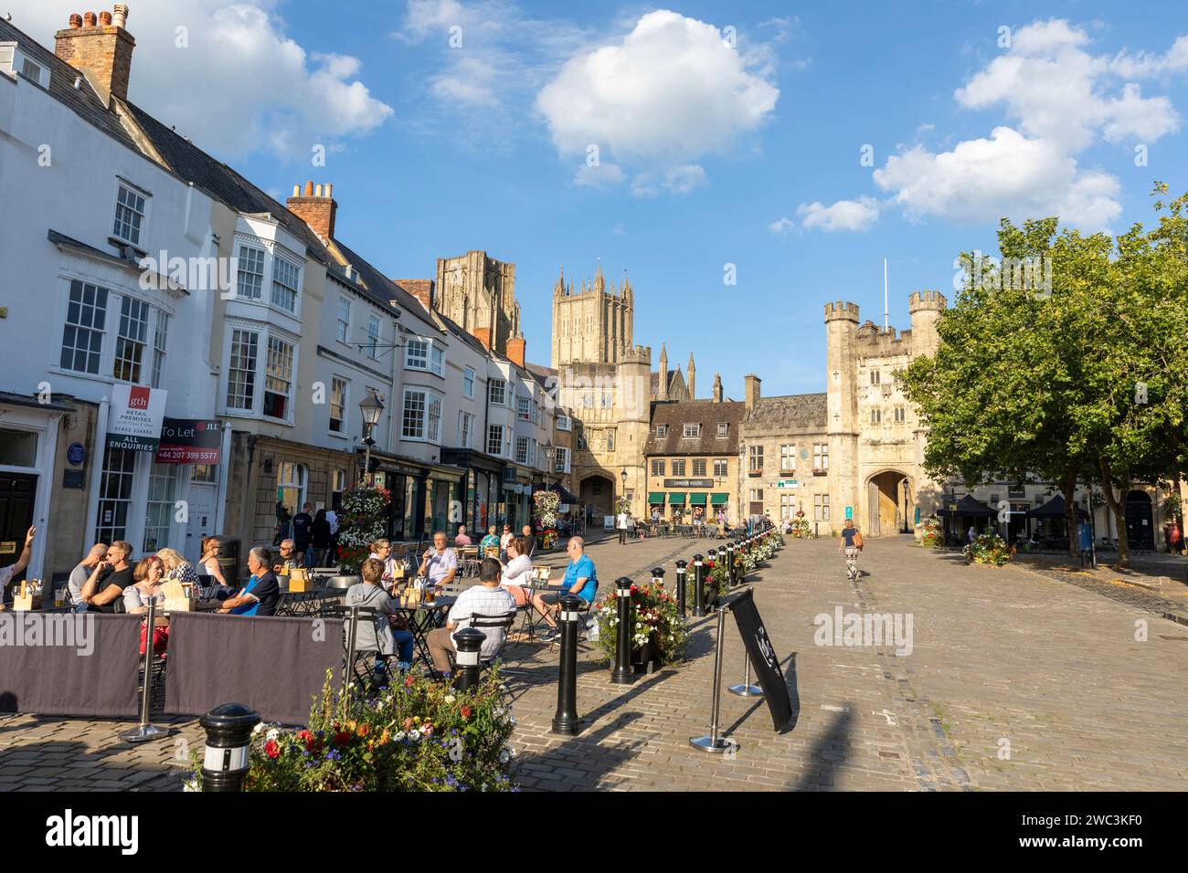 Wells Somerset city centre and Market Place hot autumn day people sitting at cafes and bars with friends, blue sky,England,UK,2023 Stock Photo
