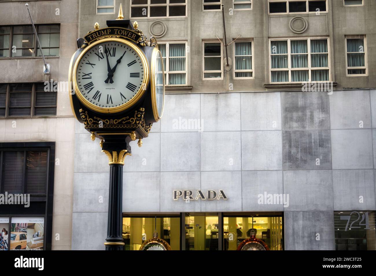The Trump Tower sidewalk clock stands across the street from the Prada store, New York City, USA  2024 Stock Photo