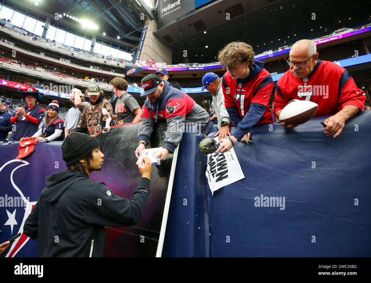 January 13, 2024: Texans quarterback C.J. Stroud (7) signs autographs for fans before the start of an NFL Wild Card playoff game between the Houston Texans and the Cleveland Browns on January 13, 2024 in Houston. (Credit Image: © Scott Coleman/ZUMA Press Wire) EDITORIAL USAGE ONLY! Not for Commercial USAGE! Stock Photo