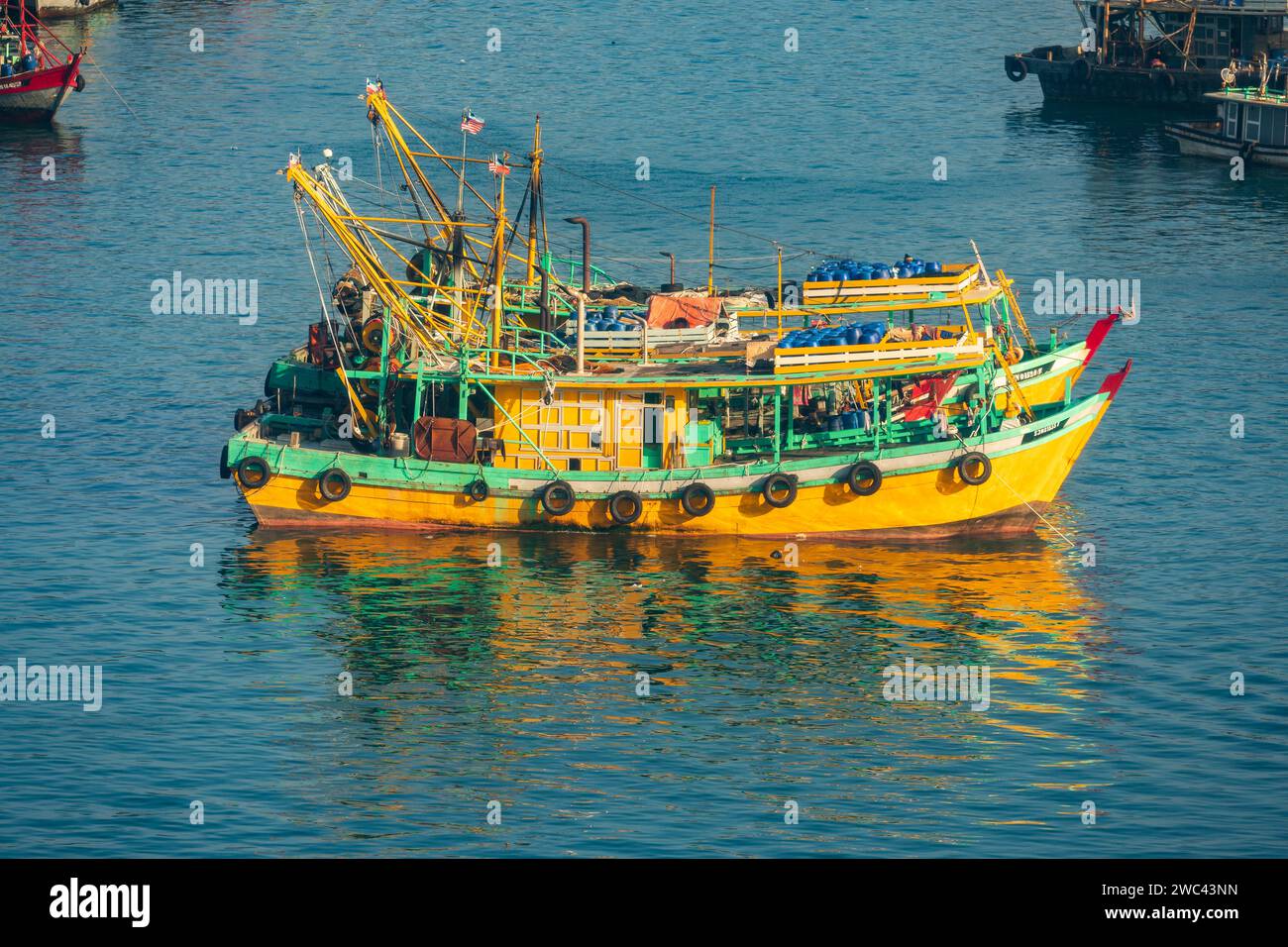 Colorful wooden fishing boats anchored in harbor Stock Photo - Alamy