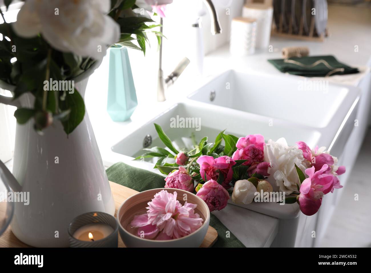 Bunch of beautiful peonies in kitchen sink Stock Photo - Alamy