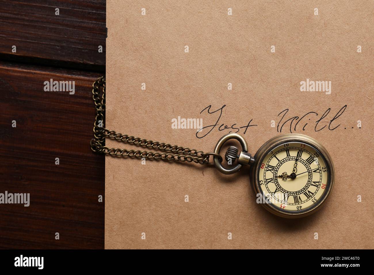 Paper with words Last Will and pocket watch on wooden table, top view Stock Photo