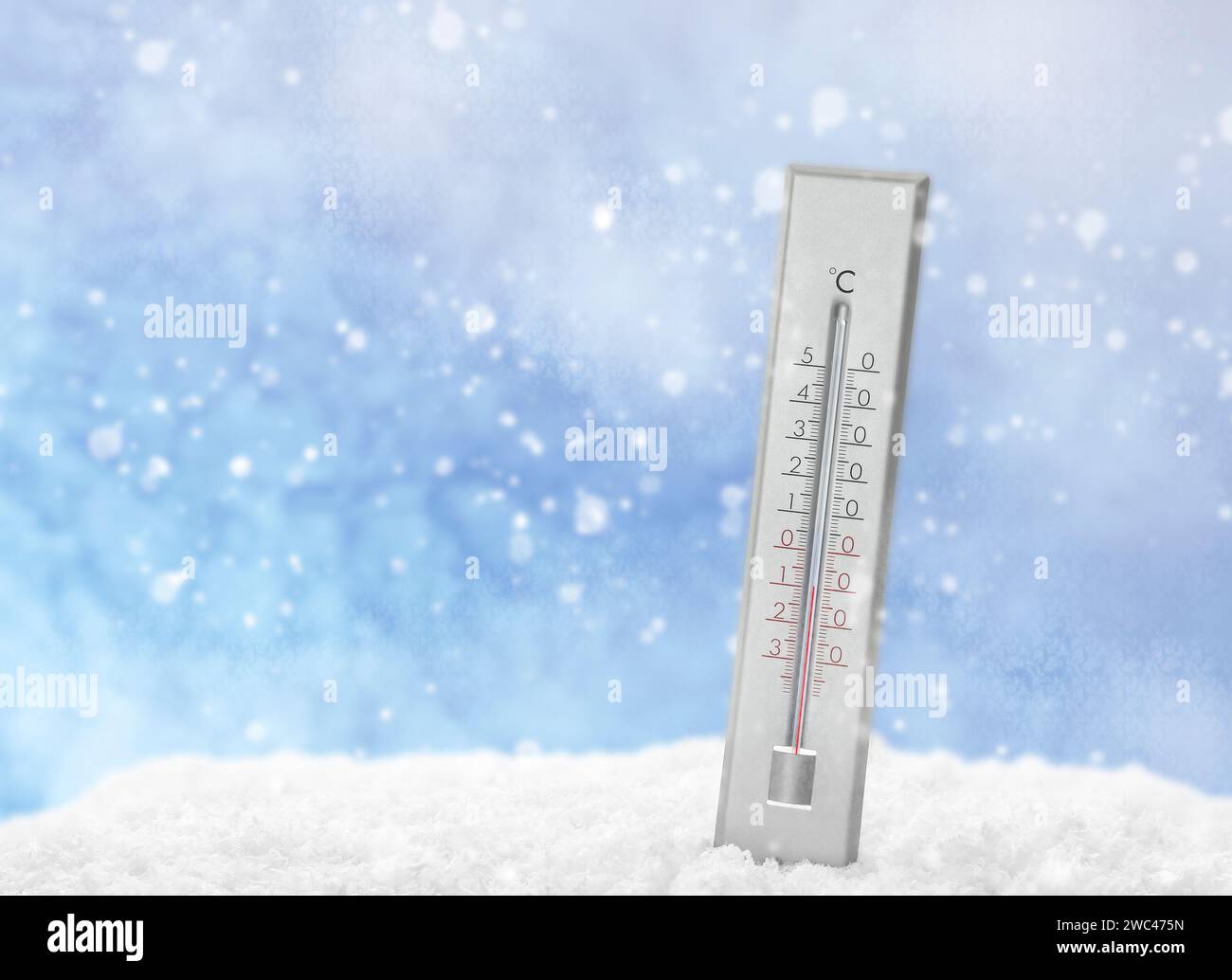 Thermometer in snow showing temperature below zero outdoors on winter day Stock Photo