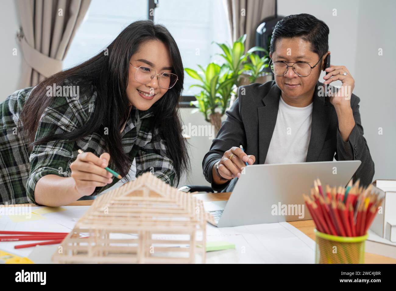Architects women and engineer working on construction site. Stock Photo