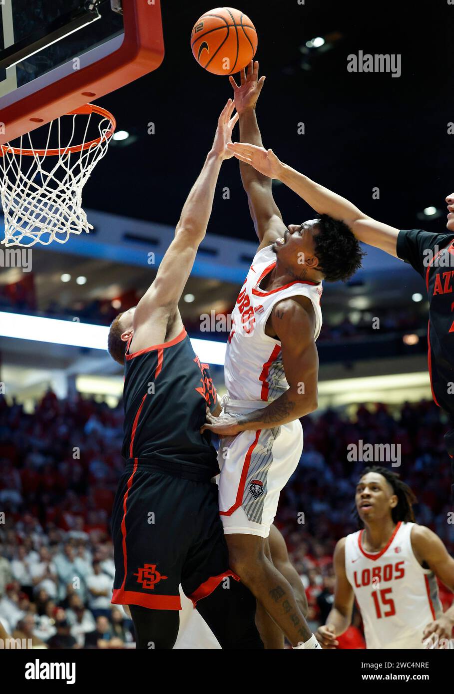 New Mexico guard Jamal Mashburn Jr. shoots and scores between San Diego