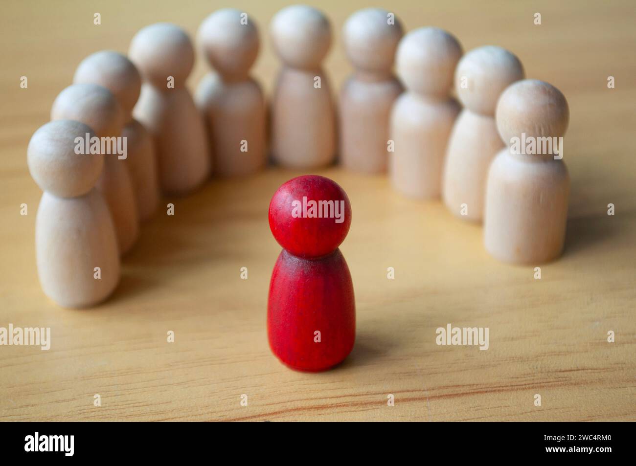 Red wooden doll as a leader discussing and giving direction the team. Leadership concept. Stock Photo