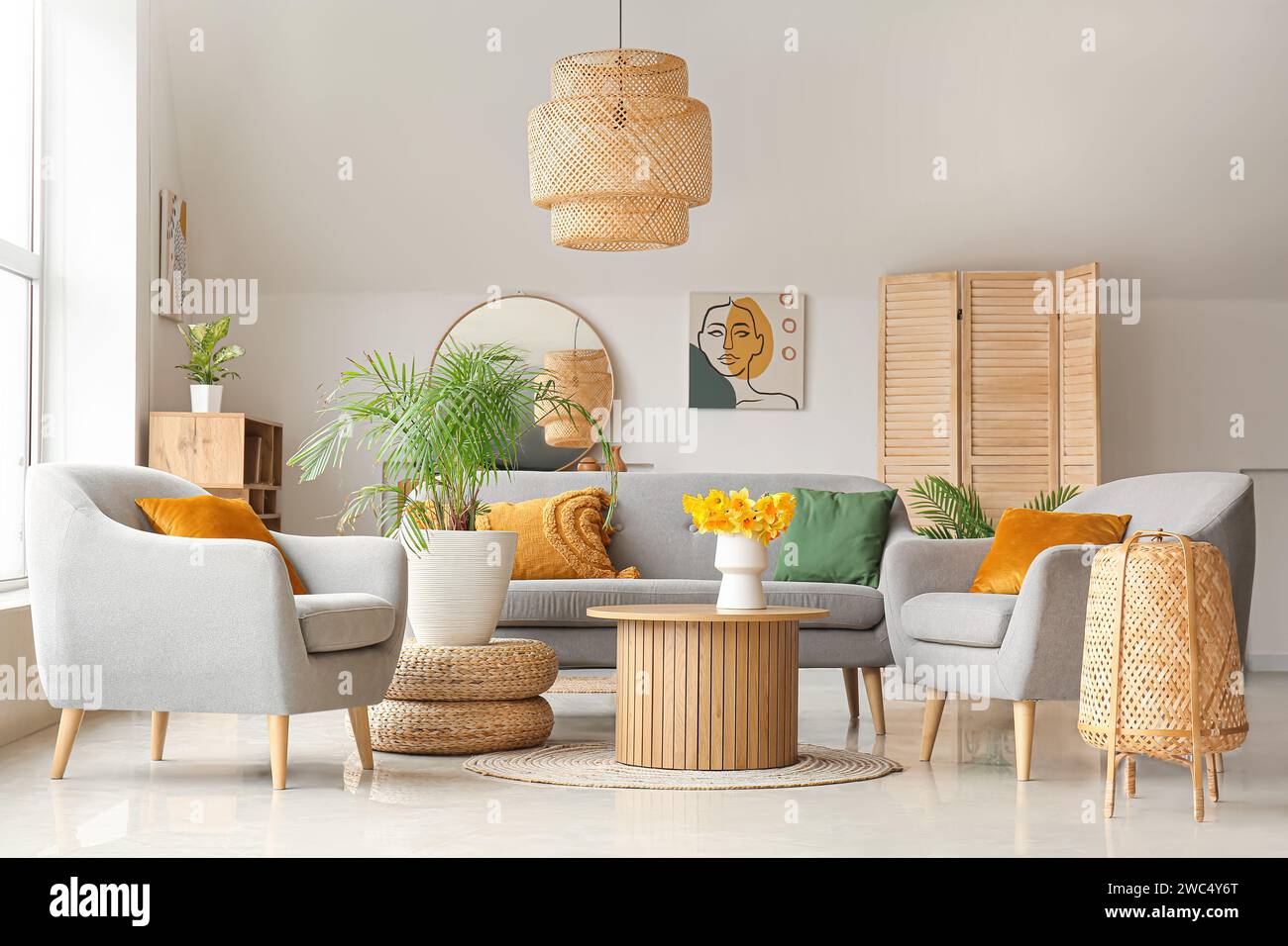 Interior of cozy living room with sofa, armchairs and flower vase on ...